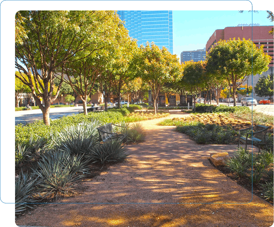 Sustainable urban park design in Dallas with native Texas trees, crushed stone pathways, and modern park benches.